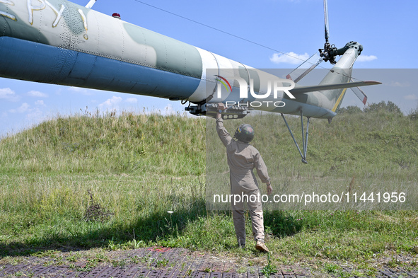 A flight engineer is checking the systems of a Mi-8MSB-V assault transport helicopter of the 16th Brody Separate Army Aviation Brigade in Uk...