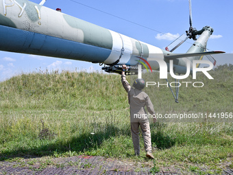 A flight engineer is checking the systems of a Mi-8MSB-V assault transport helicopter of the 16th Brody Separate Army Aviation Brigade in Uk...