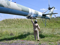 A flight engineer is checking the systems of a Mi-8MSB-V assault transport helicopter of the 16th Brody Separate Army Aviation Brigade in Uk...