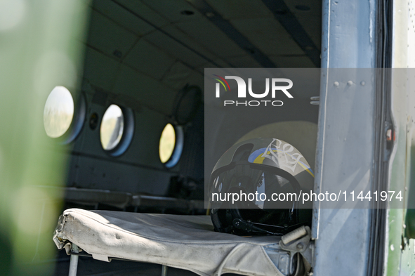 A flight helmet is being seen in a Mi-8MSB-V assault transport helicopter of the 16th Brody Separate Army Aviation Brigade in Ukraine, on Ju...