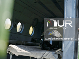 A flight helmet is being seen in a Mi-8MSB-V assault transport helicopter of the 16th Brody Separate Army Aviation Brigade in Ukraine, on Ju...