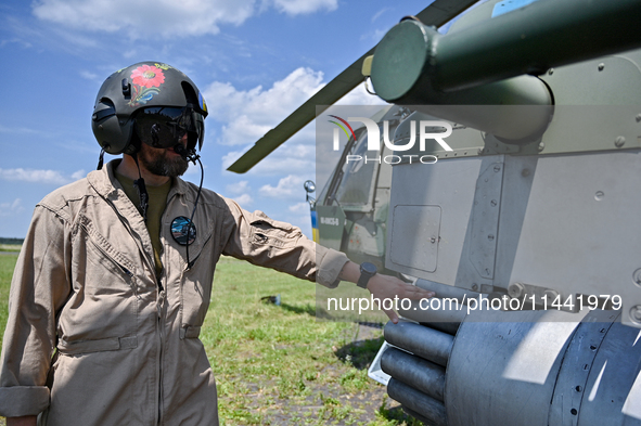 A flight engineer is checking the systems of a Mi-8MSB-V assault transport helicopter of the 16th Brody Separate Army Aviation Brigade in Uk...