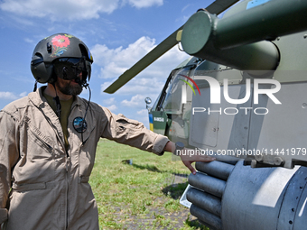 A flight engineer is checking the systems of a Mi-8MSB-V assault transport helicopter of the 16th Brody Separate Army Aviation Brigade in Uk...