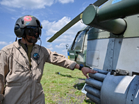 A flight engineer is checking the systems of a Mi-8MSB-V assault transport helicopter of the 16th Brody Separate Army Aviation Brigade in Uk...