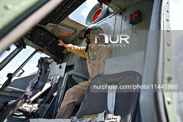 A flight engineer is checking the systems of a Mi-8MSB-V assault transport helicopter of the 16th Brody Separate Army Aviation Brigade in Uk...