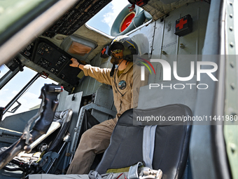 A flight engineer is checking the systems of a Mi-8MSB-V assault transport helicopter of the 16th Brody Separate Army Aviation Brigade in Uk...