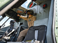 A flight engineer is checking the systems of a Mi-8MSB-V assault transport helicopter of the 16th Brody Separate Army Aviation Brigade in Uk...