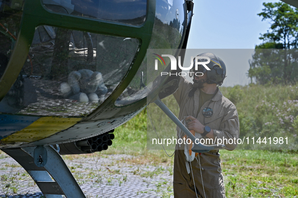 A flight engineer is checking the systems of a Mi-8MSB-V assault transport helicopter of the 16th Brody Separate Army Aviation Brigade in Uk...