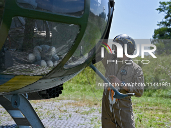 A flight engineer is checking the systems of a Mi-8MSB-V assault transport helicopter of the 16th Brody Separate Army Aviation Brigade in Uk...