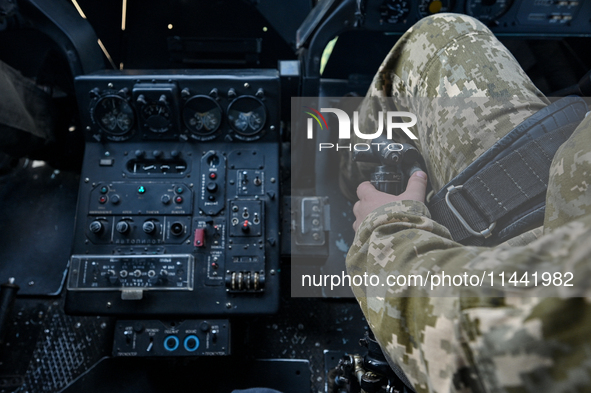 A pilot is sitting in the cockpit of a Mi-8MSB-V assault transport helicopter of the 16th Brody Separate Army Aviation Brigade in Ukraine, o...