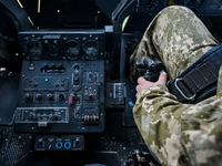 A pilot is sitting in the cockpit of a Mi-8MSB-V assault transport helicopter of the 16th Brody Separate Army Aviation Brigade in Ukraine, o...