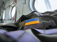 A Ukrainian flag patch is decorating a backpack of one of the crew members of a Mi-8MSB-V assault transport helicopter of the 16th Brody Sep...