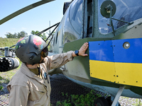 A flight engineer is checking the systems of a Mi-8MSB-V assault transport helicopter of the 16th Brody Separate Army Aviation Brigade in Uk...