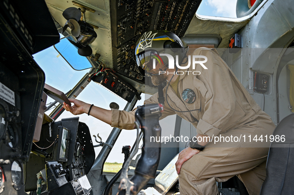 A flight engineer is checking the systems of a Mi-8MSB-V assault transport helicopter of the 16th Brody Separate Army Aviation Brigade in Uk...