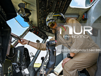 A flight engineer is checking the systems of a Mi-8MSB-V assault transport helicopter of the 16th Brody Separate Army Aviation Brigade in Uk...