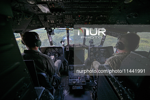 Pilots are in the cockpit of a Mi-8MSB-V assault transport helicopter of the 16th Brody Separate Army Aviation Brigade in Ukraine, on July 1...