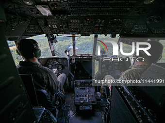 Pilots are in the cockpit of a Mi-8MSB-V assault transport helicopter of the 16th Brody Separate Army Aviation Brigade in Ukraine, on July 1...