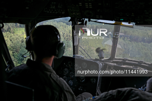 A 16th Brody Separate Army Aviation Brigade pilot is flying a Mi-8MSB-V assault transport helicopter in Ukraine, on July 11, 2024. NO USE RU...