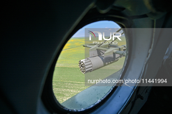 A gun is being seen through a porthole of a Mi-8MSB-V assault transport helicopter of the 16th Brody Separate Army Aviation Brigade in Ukrai...