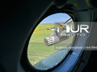 A gun is being seen through a porthole of a Mi-8MSB-V assault transport helicopter of the 16th Brody Separate Army Aviation Brigade in Ukrai...