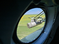 A gun is being seen through a porthole of a Mi-8MSB-V assault transport helicopter of the 16th Brody Separate Army Aviation Brigade in Ukrai...