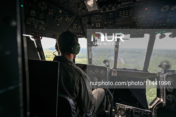 A 16th Brody Separate Army Aviation Brigade pilot is flying a Mi-8MSB-V assault transport helicopter in Ukraine, on July 11, 2024. NO USE RU...