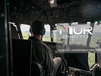 A 16th Brody Separate Army Aviation Brigade pilot is flying a Mi-8MSB-V assault transport helicopter in Ukraine, on July 11, 2024. NO USE RU...