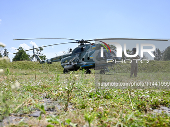 A flight engineer is standing by a Mi-8MSB-V assault transport helicopter of the 16th Brody Separate Army Aviation Brigade in Ukraine, on Ju...