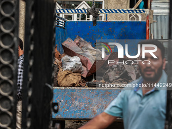 Government officials are inspecting the scrap site where 4 people died after an explosion in Sopore District, Baramulla, Jammu and Kashmir,...