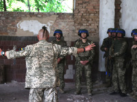 A Shkval (Squall) Battalion serviceman sporting an oseledets hairstyle is facing other soldiers in Ukraine, on July 26, 2024. Former prisone...