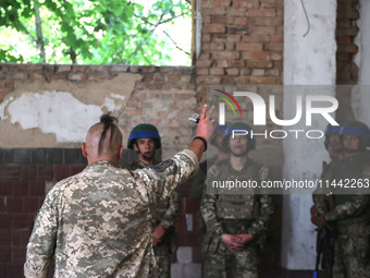 A Shkval (Squall) Battalion serviceman with an oseledets hairstyle is facing other soldiers in Ukraine, on July 26, 2024. Former prisoners w...