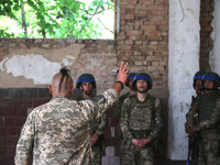 A Shkval (Squall) Battalion serviceman with an oseledets hairstyle is facing other soldiers in Ukraine, on July 26, 2024. Former prisoners w...