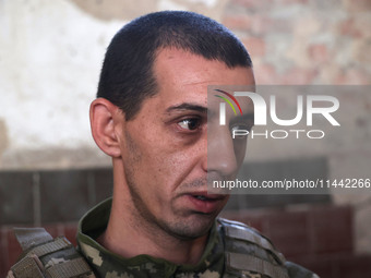 A serviceman who goes by the call sign Budulai is a Shkval (Squall) Battalion member in Ukraine, on July 26, 2024. Former prisoners who volu...