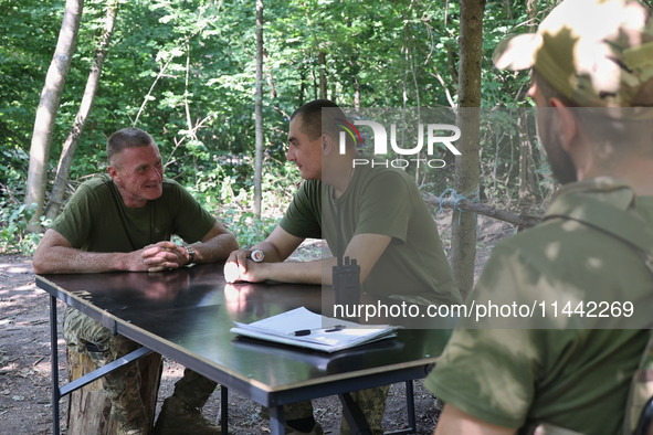 Pavlo (left) is serving as a squad commander at the Shkval (Squall) Battalion in Ukraine, on July 26, 2024. Former prisoners who volunteered...