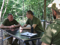 Pavlo (left) is serving as a squad commander at the Shkval (Squall) Battalion in Ukraine, on July 26, 2024. Former prisoners who volunteered...