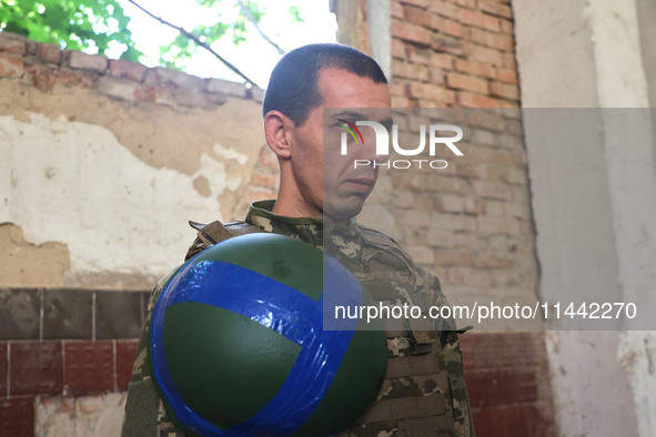 A serviceman who goes by the call sign Budulai is a Shkval (Squall) Battalion member in Ukraine, on July 26, 2024. Former prisoners who volu...