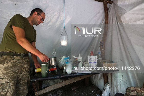 A Shkval (Squall) Battalion serviceman is staying in the tent in Ukraine, on July 26, 2024. Former prisoners who volunteered to defend Ukrai...