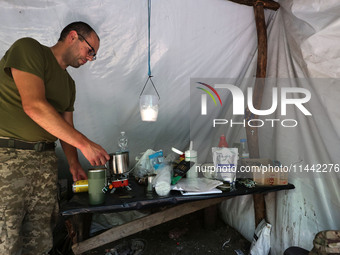 A Shkval (Squall) Battalion serviceman is staying in the tent in Ukraine, on July 26, 2024. Former prisoners who volunteered to defend Ukrai...