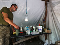 A Shkval (Squall) Battalion serviceman is staying in the tent in Ukraine, on July 26, 2024. Former prisoners who volunteered to defend Ukrai...