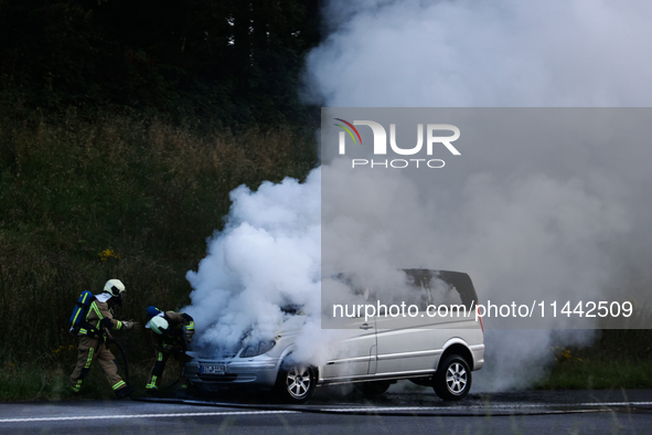 A car is seen on fire at the highway in Belgium on July 28, 2024. 