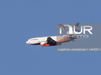 Tanker 912, a DC-10 Air Tanker used to fight fires, is flying past North Table Mountain Ecological Reserve, near the Park Fire, in Oroville,...