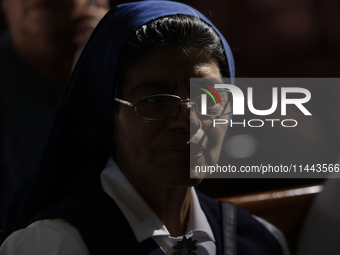 People are participating in a mass where the relics of St. Jude Thaddeus are being exhibited inside the Metropolitan Cathedral in Mexico Cit...