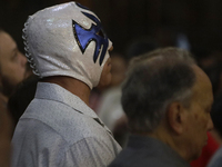 Atlantis, a wrestler, is observing the relics of St. Jude Thaddeus while wearing a mask inside the Metropolitan Cathedral in Mexico City, Me...