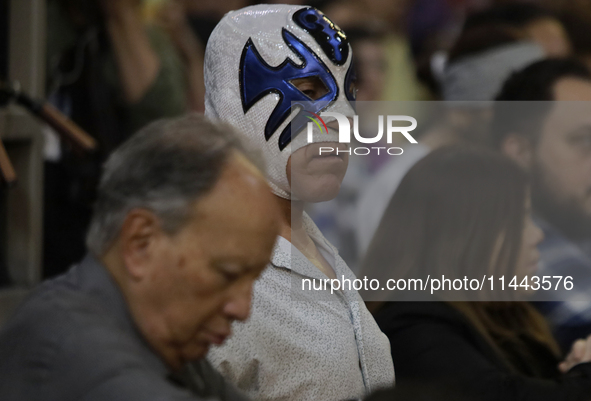 Atlantis, a wrestler, is observing the relics of St. Jude Thaddeus while wearing a mask inside the Metropolitan Cathedral in Mexico City, Me...