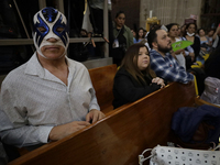 Atlantis, a wrestler, is observing the relics of St. Jude Thaddeus while wearing a mask inside the Metropolitan Cathedral in Mexico City, Me...