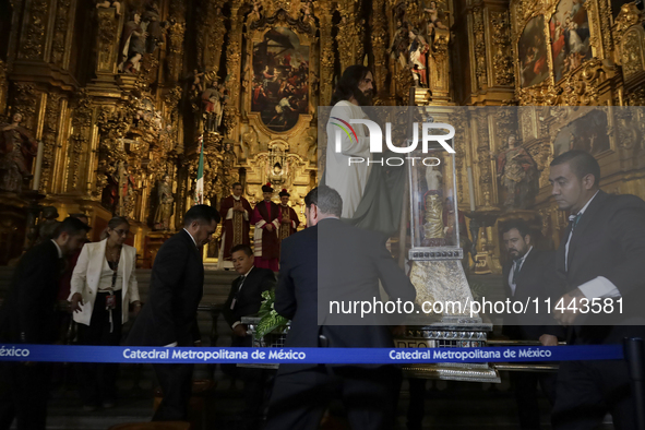 A group of people is arranging relics of St. Jude Thaddeus inside the Metropolitan Cathedral in Mexico City, Mexico, a work being carried ou...