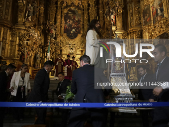 A group of people is arranging relics of St. Jude Thaddeus inside the Metropolitan Cathedral in Mexico City, Mexico, a work being carried ou...