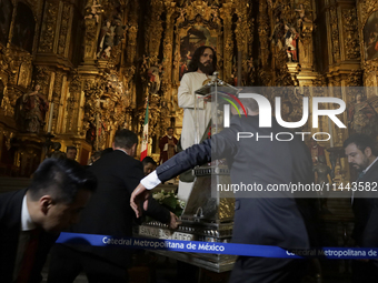 A group of people is arranging relics of St. Jude Thaddeus inside the Metropolitan Cathedral in Mexico City, Mexico, a work being carried ou...