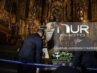 A group of people is arranging relics of St. Jude Thaddeus inside the Metropolitan Cathedral in Mexico City, Mexico, a work being carried ou...