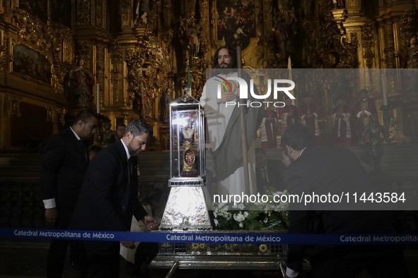 A group of people is arranging relics of St. Jude Thaddeus inside the Metropolitan Cathedral in Mexico City, Mexico, a work being carried ou...